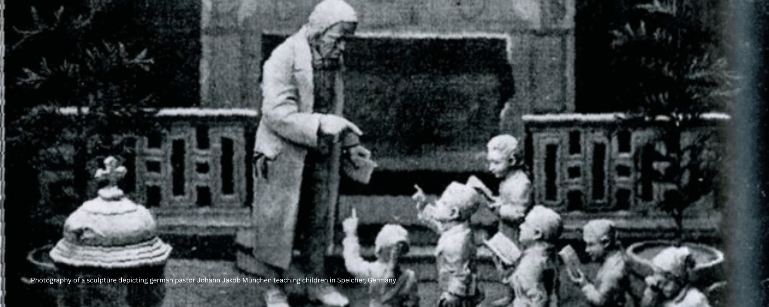 photography of a sculpture depicting german pastor Johann Jakob München teaching children in Speicher, Germany